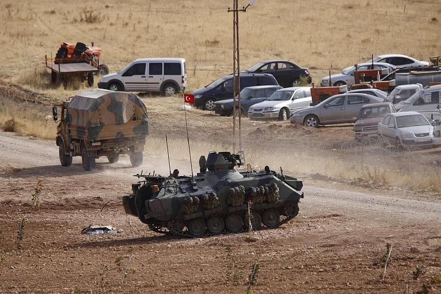 A Turkish military armoured vehicle takes position on the Turkish-Syrian border near the south-eastern Turkish town of Suruc in Sanliurfa province on Oct 3, 2014. Damascus has said that any Turkish military intervention on Syrian soil would be consid