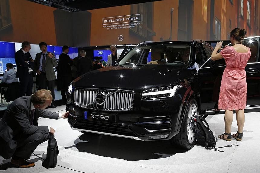 People look at a Volvo XC90 displayed on media day at the Paris Mondial de l'Automobile Oct 2, 2014. The Paris auto show opens its doors to the public from October 4 to October 19. -- PHOTO: REUTERS