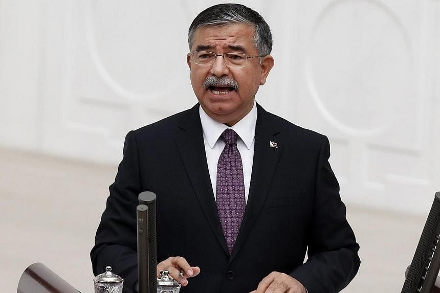 Turkey's Defence Minister Ismet Yilmaz speaks during a debate on a motion which would allow the government to authorise cross-border military incursions against Islamic State fighters in Syria and Iraq, and allow coalition forces to use Turkish terri