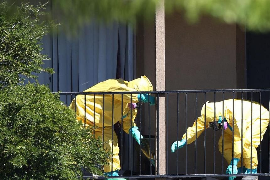 A hazmat team arrives to clean a unit at the Ivy Apartments, where the confirmed Ebola virus patient was staying,&nbsp;in Dallas, Texas&nbsp;on Oct 3, 2014. -- PHOTO: AFP