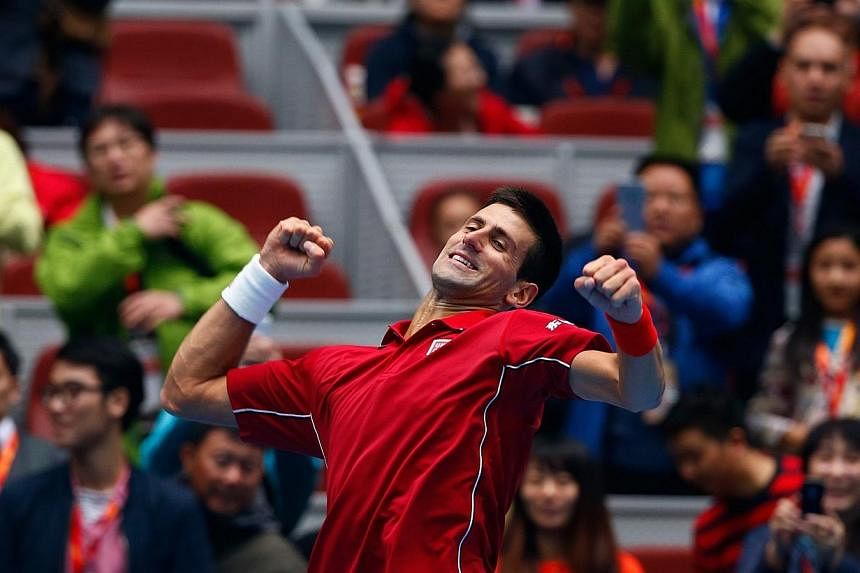 Novak Djokovic of Serbia celebrates after winning against Andy Murray of Britain during their men's singles semi-final match at the China Open tennis tournament in Beijing on Oct 4, 2014.&nbsp;World No. 1 Novak Djokovic maintained his perfect tournam