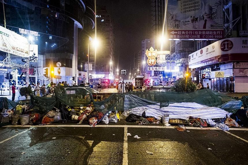 A rebuilt barricade is seen at Mongkok district during clashes between rival protest groups in Hong Kong, on Oct 4, 2014. -- PHOTO: AFP