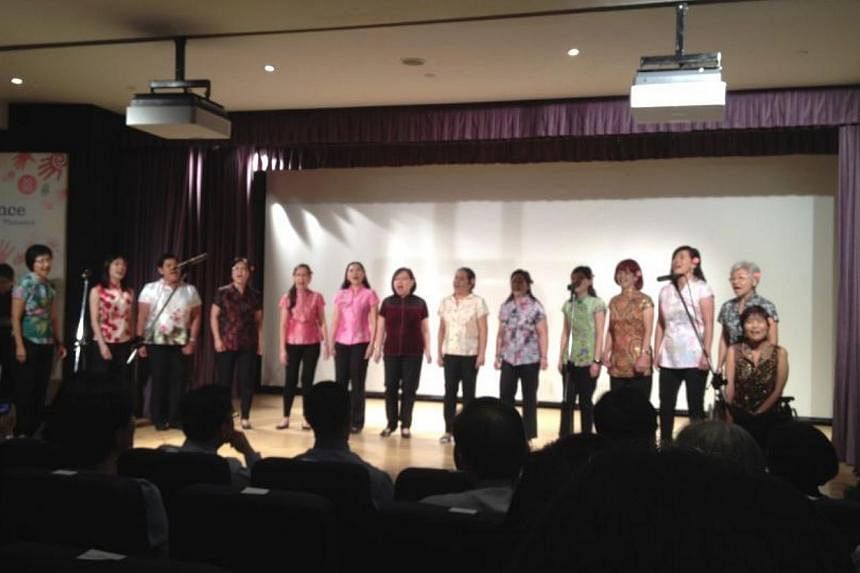 Members of the KKH choir presenting their renditions of "Memory" and "Ye Lai Xiang" to over 400 healthcare pioneers at the hospital's pioneer generation tribute event on Saturday. -- ST PHOTO: JOANNA SEOW