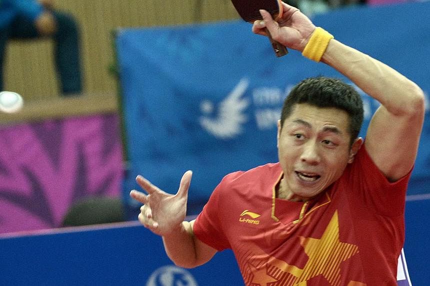 China's Xu Xin competes against South Korea's Lee Jungwoo in the table tennis men's team finals during the 2014 Asian Games at the Suwon Gymnasium in Incheon on Sept 30, 2014. -- PHOTO: AFP