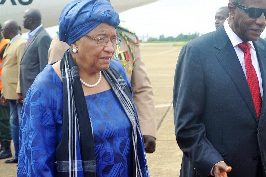 Liberian President Ellen Johnson Sirleaf - seen here (above, left)&nbsp;on August 1, 2014 visiting Guinea, with&nbsp;President of Guinea Alpha Conde (right) -&nbsp;said a man diagnosed with Ebola in Texas behaved irresponsibly when he travelled after