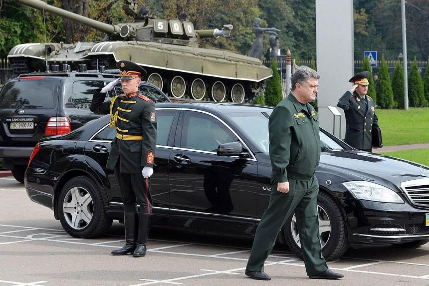 Ukrainian President Petro Poroshenko visits the Academy of Ground Forces in Lviv on Oct 3, 2014. Poroshenko risked further angering the Kremlin by suggesting that English lessons replace Russian ones in schools to improve the country's standard of li
