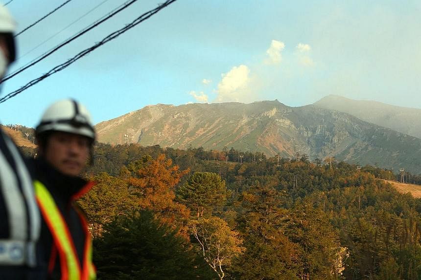 White smoke rises from Mount Ontake at Nagano prefecture on Oct 4, 2014, one week after the volcano erupted. -- PHOTO: AFP