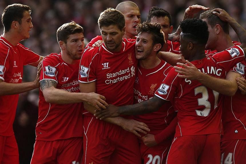 Liverpool celebrate their opening goal against Aston Villa at Anfield on Oct 4, 2014.&nbsp;-- PHOTO: REUTERS&nbsp;