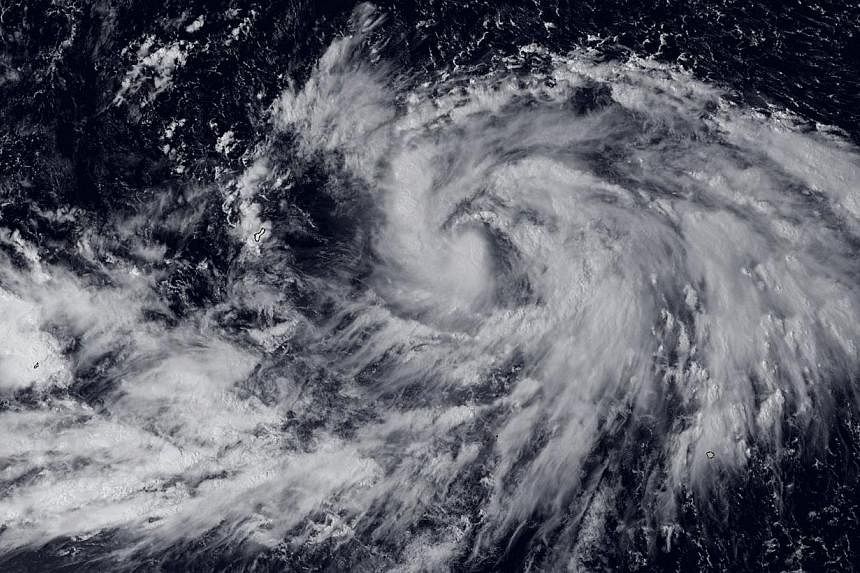 Typhoon Phanfone, which barrelled into south-western Japan with heavy rain and wind that caused flights to be cancelled flights and knocked out power, is on course to brush Tokyo on Monday. -- PHOTO: AFP