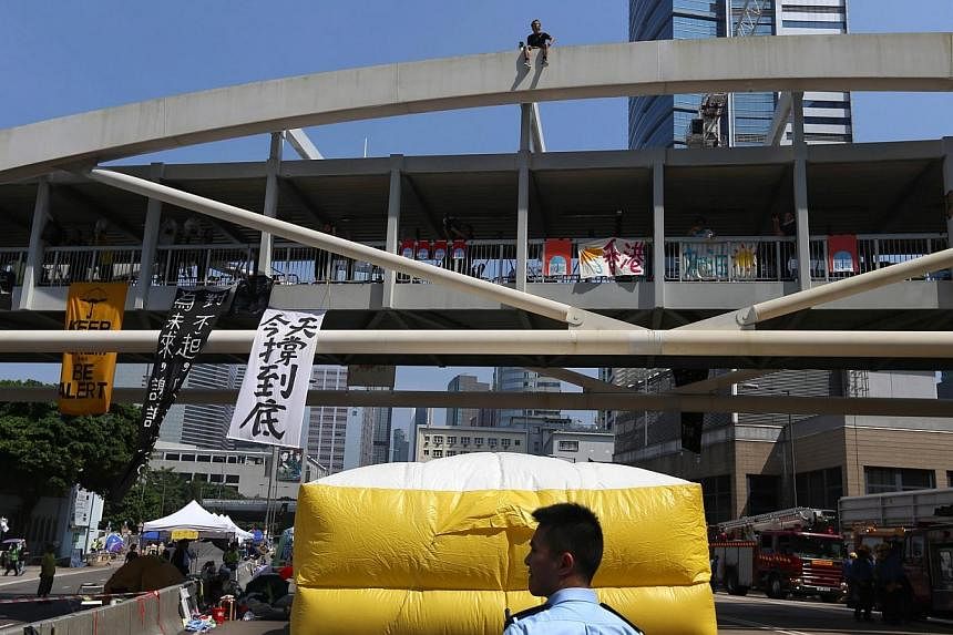 Firefighters put up a huge inflatable cushion under the bridge in case he fell, Radio Television Hong Kong reported.&nbsp;-- PHOTO: AFP