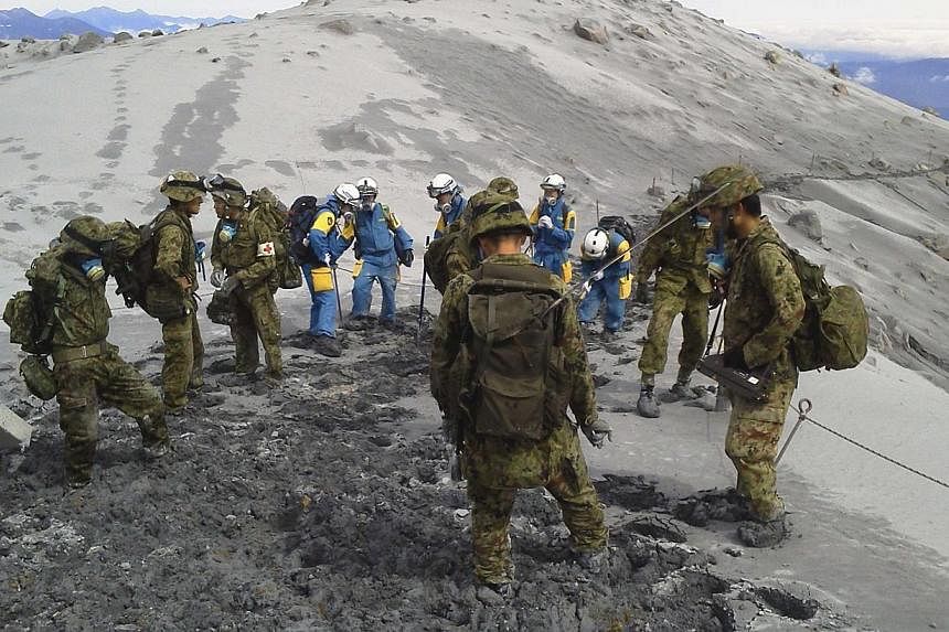 Japan Self-Defence Force (JSDF) soldiers conduct rescue operations on the Mount Ontake, which erupted on Sept 27, 2014.&nbsp;A search operation for people missing on a volcano in central Japan was called off on Sunday, Oct 5, more than a week after a