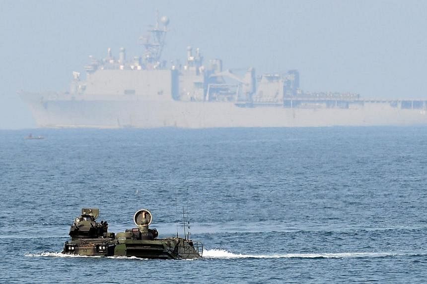Two assault vehicles (AAV) of the US marines 31st Marine Expeditionary Unit based in Okinawa Japan, manoeuvre in high seas before USS Germantown as part of the 12-day US and Philippine annual joint naval exercise dubbed "Phiblex" along the coast in S