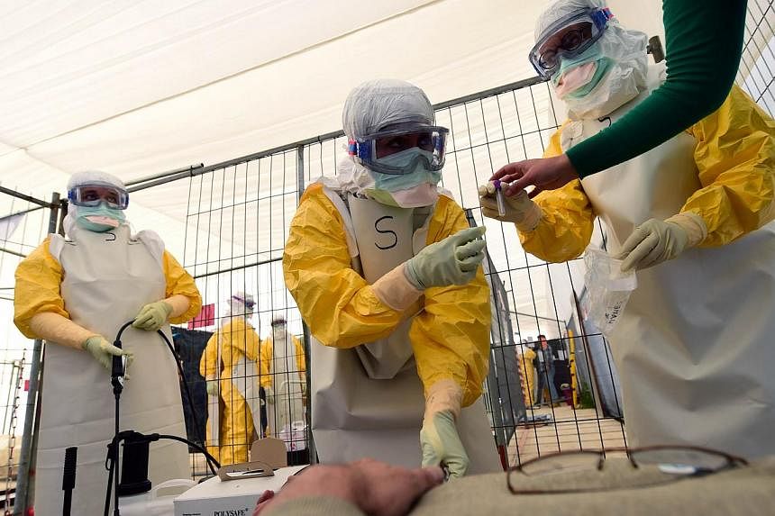 Volunteers train at a Doctors Without Borders (MSF) replica of Ebola treatment centres, prior to be sent to help fight the spread of the deadly virus in Africa, in Brussels, on Oct 1, 2014.&nbsp;Scientists have used Ebola disease spread patterns and 