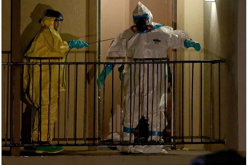 Members of the Cleaning Guys Haz Mat clean up company work on sanitising the apartment where Ebola patient Thomas Eric Duncan was staying before being admitted to a hospital on Oct 5, 2014, in Dallas, Texas.The first Ebola patient diagnosed in the Un