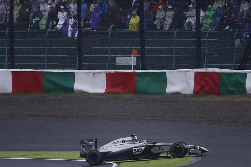 McLaren Formula One driver Kevin Magnussen of Denmark spins unto the grass during the Japanese F1 Grand Prix at the Suzuka Circuit on Oct 5, 2014. -- PHOTO: REUTERS