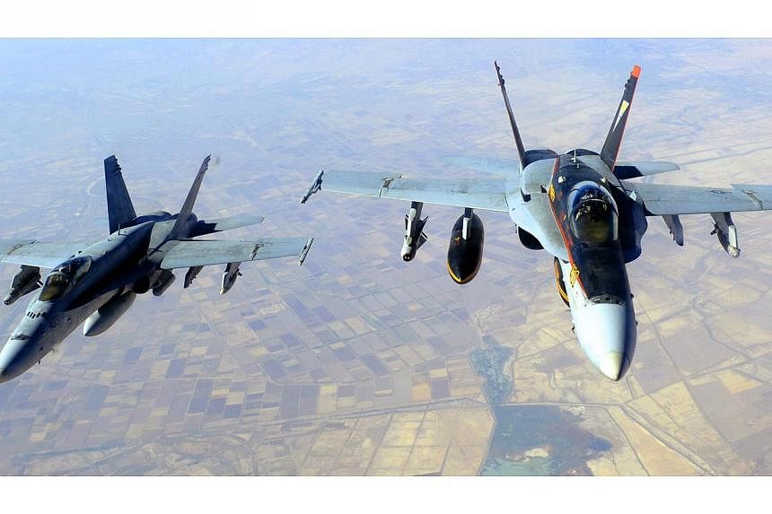 This Oct 4, 2014, US Navy handout image shows two US Navy F-18E Super Hornets supporting operations against IS, after being refueled by a KC-135 Statotanker over Iraq after conducting an airstrike.&nbsp;The US military unleashed a wave of air strikes