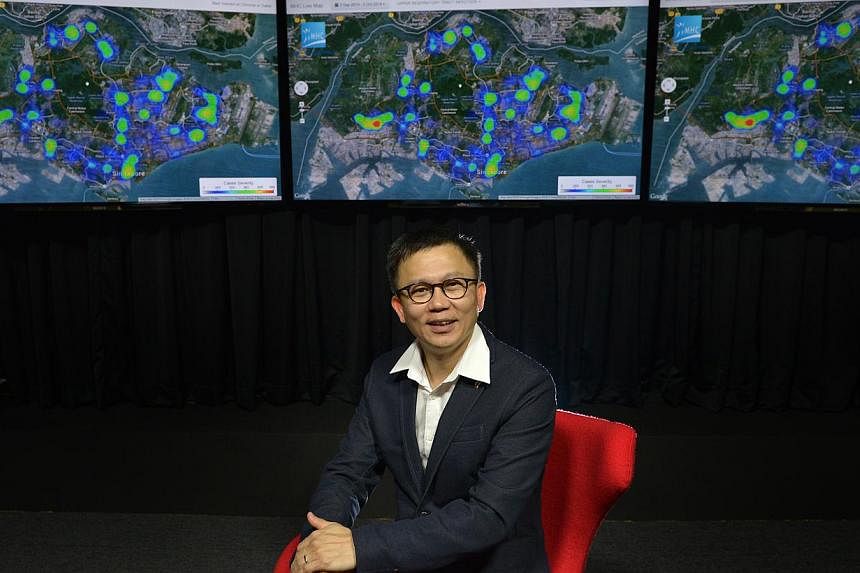 Dr Low Lee Yong, founder of Make Health Connect (MHC), with a projection of the live disease map showing hotspots of illnesses doctors dealt with.