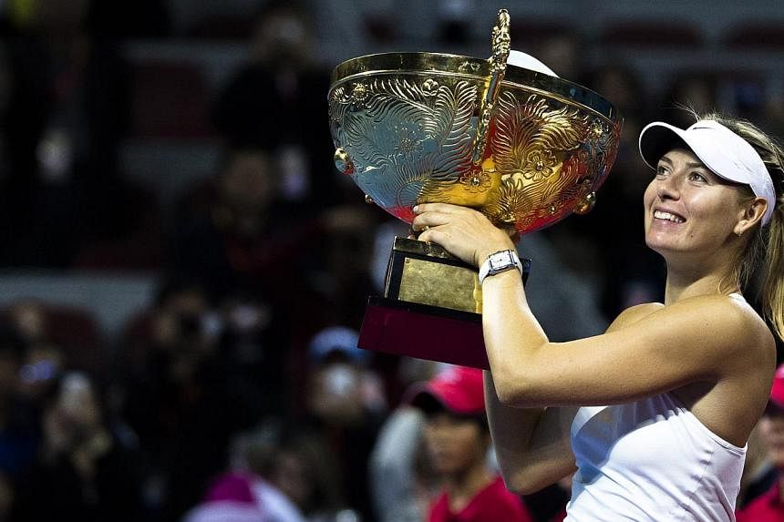 Maria Sharapova with her trophy from the China Open on in Beijing on Oct 5, 2014. -- PHOTO: REUTERS&nbsp;