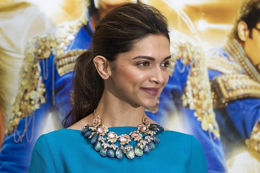 Indian Bollywood actress and model Deepika Padukone poses for photographers at the Happy New Year photo call in London on Oct 5, 2014. -- PHOTO: AFP