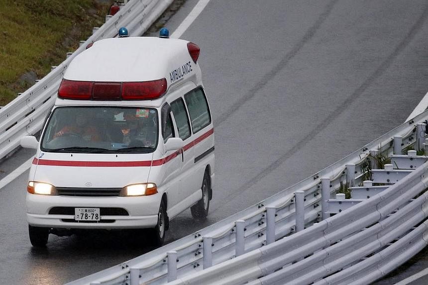An ambulance is dispatched after the race was stopped following a crash by Marussia Formula One driver Jules Bianchi of France at the Japanese F1 Grand Prix at the Suzuka Circuit on Oct 5, 2014. -- PHOTO: REUTERS