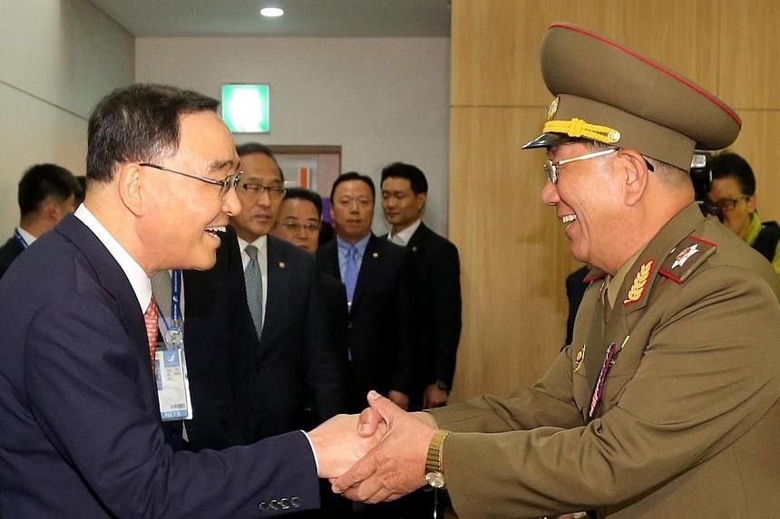 South Korean Prime Minister Chung Hong Won (left) shakes hands with Hwang Pyong So (right), director of the military's General Political Bureau, the top military post in North Korea, during their meeting in Incheon on Oct 4, 2014.&nbsp;South Korea on