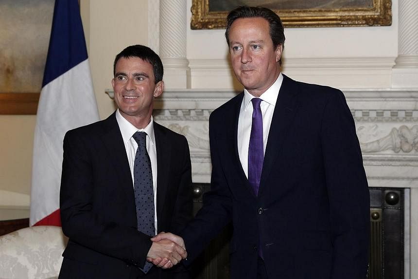 Britain's Prime Minister David Cameron (right) meets with French Prime Minister Manuel Valls at 10 Downing Street in London, on Oct 6, 2014.&nbsp;Mr Valls, on Monday, warned that Britain would "lose a lot" if it were to leave the European Union. -- P