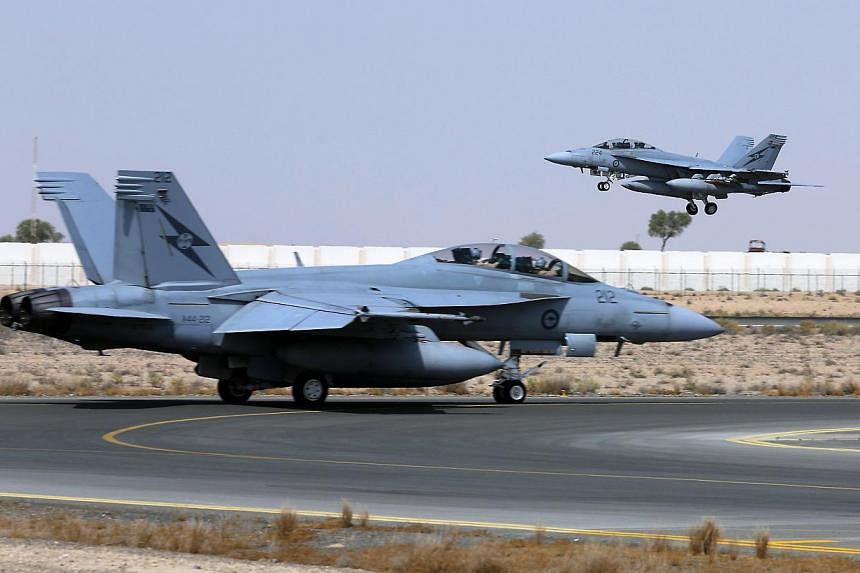 A Royal Australian Air Force (RAAF) F/A-18F Super Hornet takes off as another taxis along the runway as they start their first combat mission over Iraq in this picture released by the Australian Defence Force on Oct 6, 2014.&nbsp;Australian fighter j