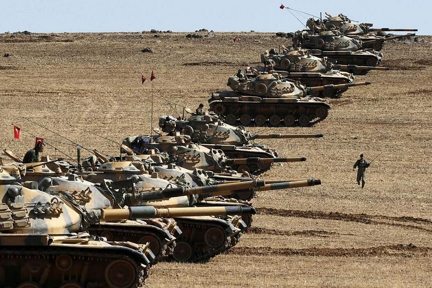 Turkish army tanks take up position on the Turkish-Syrian border near the south-eastern town of Suruc in Sanliurfa province Oct 6, 2014.&nbsp;The fight against the Islamic State in Iraq and Syria (ISIS) group will be difficult and could last decades 