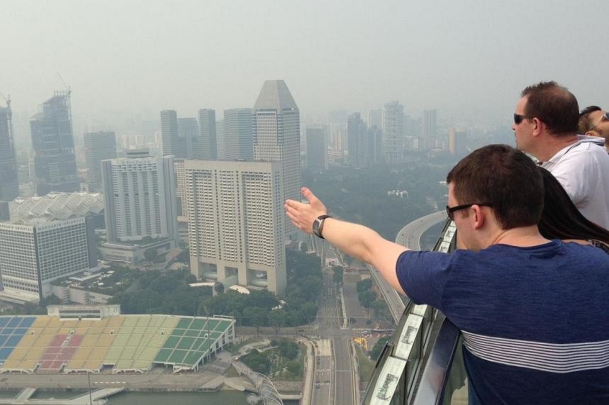 The Singapore skyline shrouded in haze as seen from the MBS Skypark on Oct 6, 2014, at 3pm. -- ST PHOTO: CAROLINE CHIA