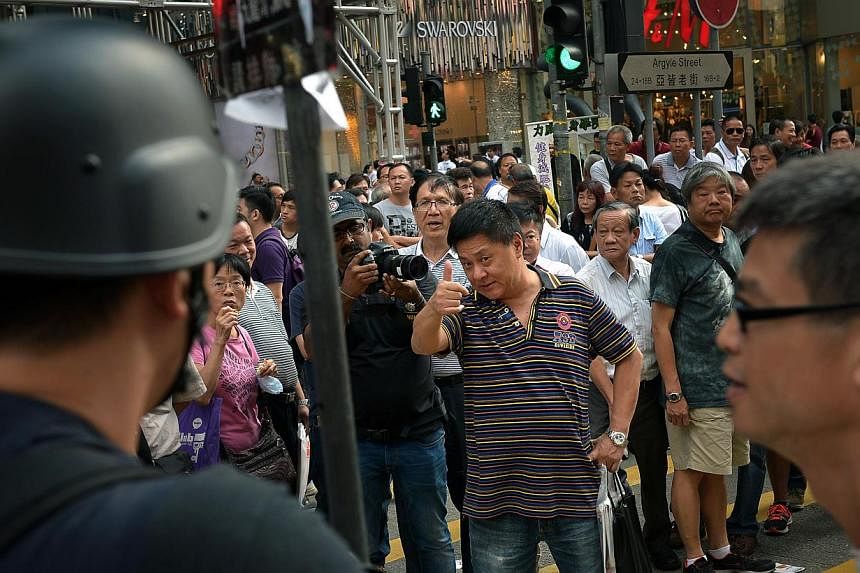 An anti-protester taunts the protesters at Mong Kok in Kowloon on Oct 6, 2014.&nbsp;A four-day environment symposium which was to gather 11 Nobel laureates in Hong Kong from Wednesday, has been scrapped due to "sustained disruptions in the city," the