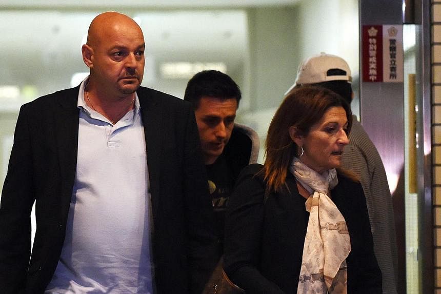 Parents of Marussia driver Jules Bianchi of France, Philippe (left) and Christine (right), leave the Mie General Medical Centre in Yokkaichi on Oct 7, 2014. -- PHOTO: AFP