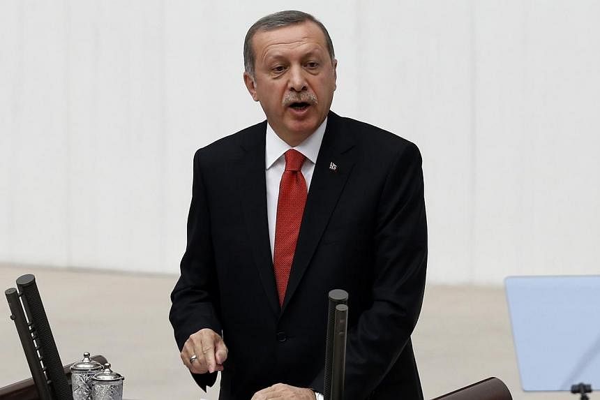 Turkey's President Tayyip Erdogan addresses the Turkish Parliament during a debate marking the reconvene of the parliament in Ankara on Oct 1, 2014. Mr Erdogan warned on Tuesday that the Syrian border town of Kobane is on the verge of falling to mili