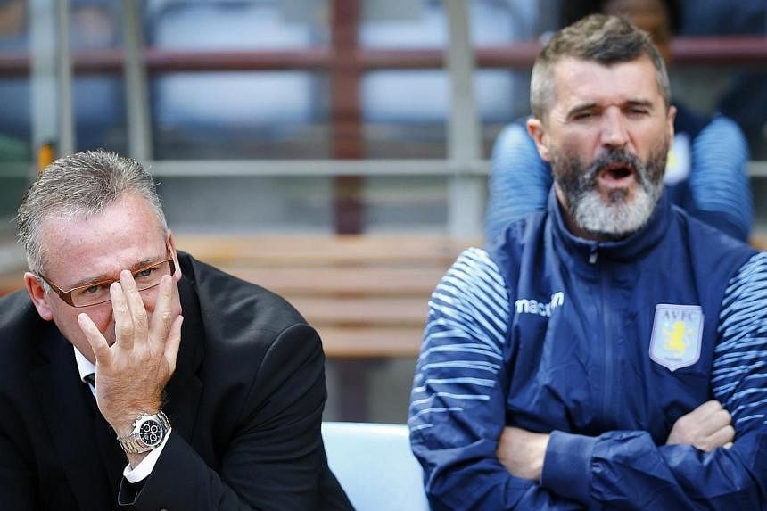 Aston Villa manager Paul Lambert (left) and his assistant Roy Keane sit in the dugout before their English Premier League soccer match against Newcastle United in Birmingham, on Aug 23, 2014. Leaked extracts from Keane's new autobiography show that t