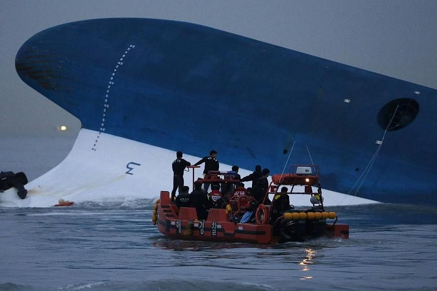 Maritime police search for missing passengers in front of the South Korean Sewol ferry which sank at sea, off Jindo on April 16, 2014.&nbsp;The ship's captain at the heart of South Korea's ferry disaster acknowledged during his murder trial Tuesday t
