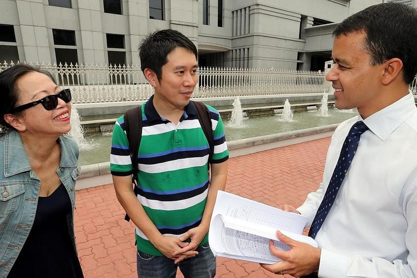 (From left) Ms Shelley Thio and Mr Jolovan Wham, from Stop Trafficking SG, deliver their petition to MP Christopher De Souza, outside Parliament House on Tuesday.&nbsp;-- ST PHOTO:&nbsp;WONG KWAI CHOW