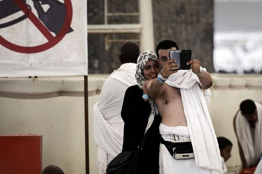 The trend of taking selfies has caught on at this year's haj. Key stages of the religious gathering, including the stoning of Satan (above) in Mina, near the holy city of Mecca, last Saturday have been recorded on mobile devices for posterity and for
