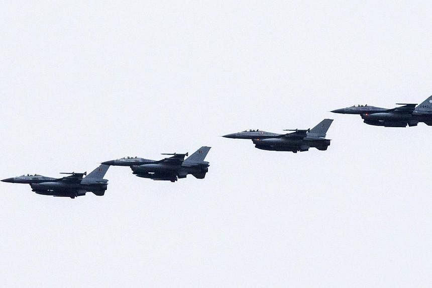 Four Dutch F-16s fly near the Leeuwarden Airbase near Leeuwarden on Sept 25, 2014.&nbsp;Dutch F-16s on Tuesday carried out their first strikes on the Islamic State in Iraq and Syria (ISIS) group in Iraq, the defence ministry said, with militants poss