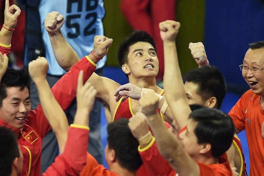 Hosts China won a record sixth straight world men's gymnastics team title on Tuesday night, with their final performer overturning the lead set by arch-rivals Japan at the last moment. -- PHOTO: AFP
