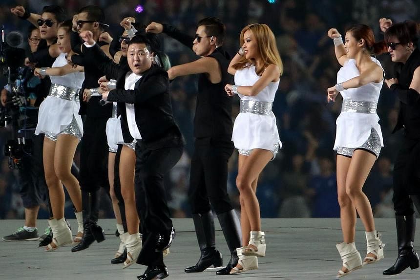 Popular South Korean pop star Psy performs his trademark Gangnam Style hit with his dancers, ensuring the Asian Games opening ceremony ends on a high at the Incheon Asiad Main Stadium, in incheon, South Korea on Sept 19, 2014. -- PHOTO: ST FILE