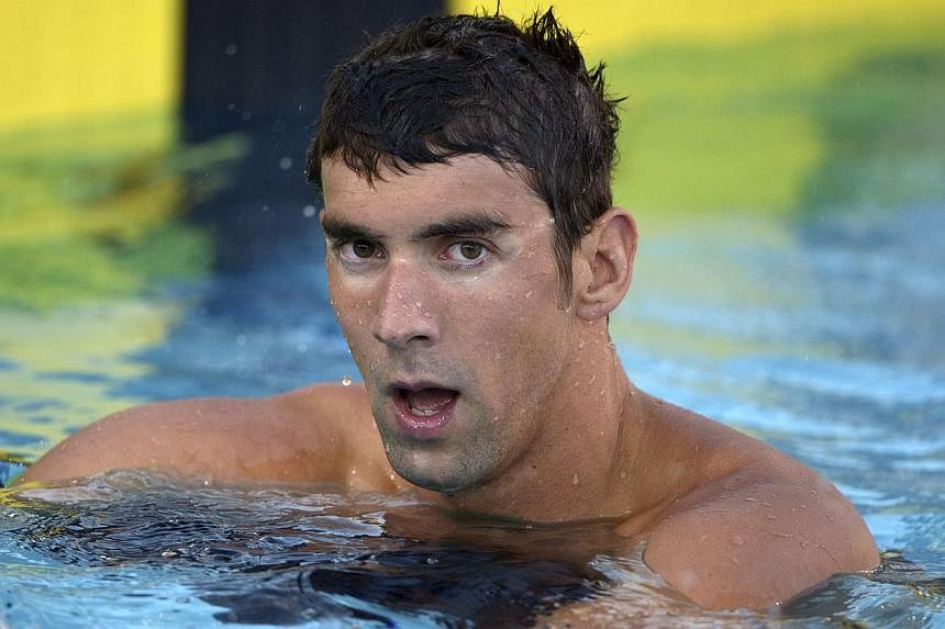 Michael Phelps, the 18-time Olympic swim champion arrested last week for drink driving, has been banned for six months and dropped from the 2015 FINA World Swimming Championships roster in Russia next August. -- PHOTO: REUTERS