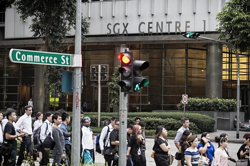 Shares fell after a return to trade following Monday's break for a public holiday, with the Straits Times Index ending the day down by 9.25 points or 0.28 per cent at 3,243.99. -- PHOTO: BLOOMBERG