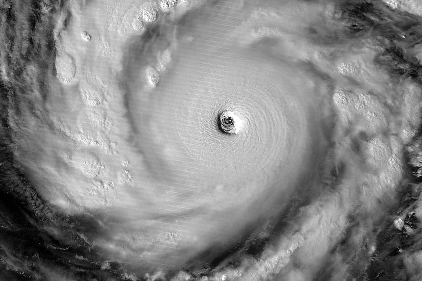 This image of Super Typhoon Vongfong using NASA’s Visible Infrared Imaging Radiometer Suite (VIIRS), obtained on Oct 8, 2014 courtesy of NASA, shows the storm illuminated by moonlight. The super typhoon, on course to hit Japan over the weekend, is 