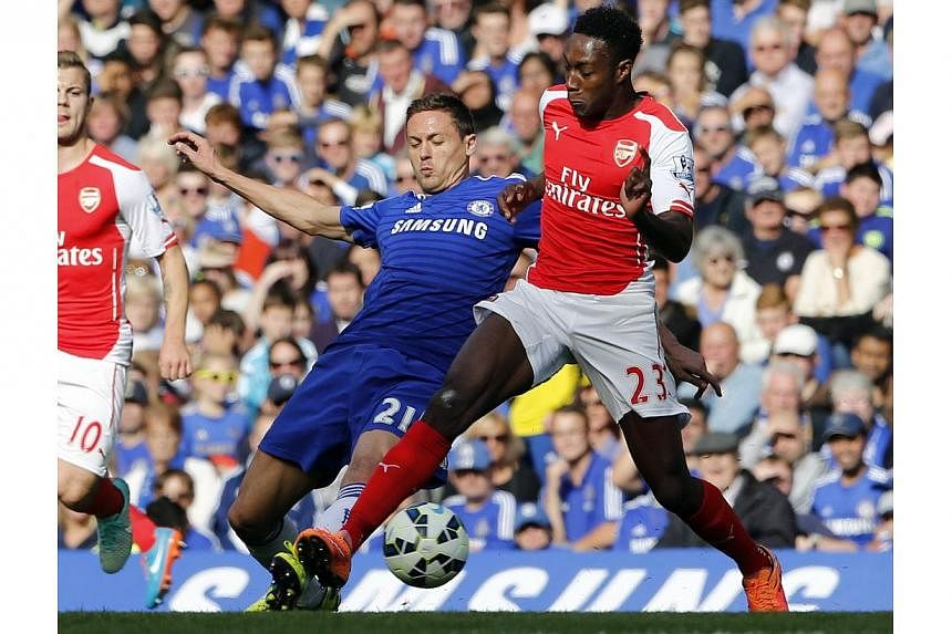 Chelsea's Nemanja Matic (left) challenges Arsenal's Danny Welbeck during their English Premier League soccer match at Stamford Bridge in London on Oct 5, 2014.&nbsp;English Premier League clubs have discussed playing a regular season round of 10 matc