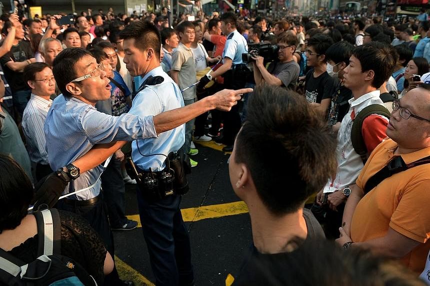A demonstrator against the Occupy Central movement shouting at protesters in Mongkok, Hong Kong on Oct 3, 2014, as police separated the two camps.&nbsp;The Occupy Central movement not only marks a stand-off between protesters and the Hong Kong and Be