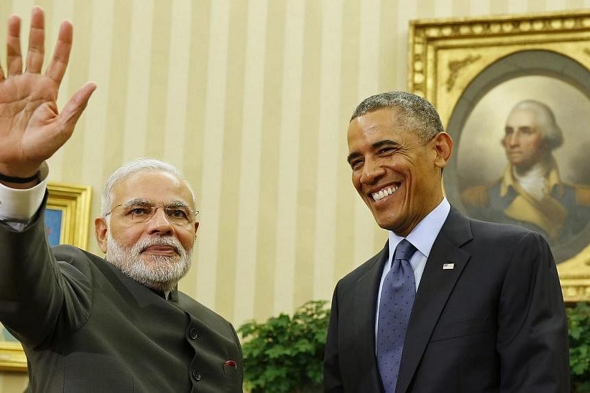 US President Barack Obama smiles as he hosts a meeting with India's Prime Minister Narendra Modi in the Oval Office of the White House in Washington on Sept 30, 2014.&nbsp;-- PHOTO: REUTERS