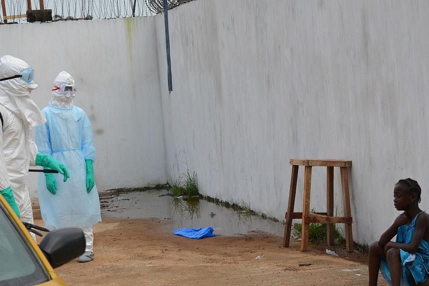 A girl cries outside the "Island Clinic", a new Ebola treatment centre that opened in Monrovia after the death of her parents by the disease on Sept 23, 2014. -- PHOTO: AFP