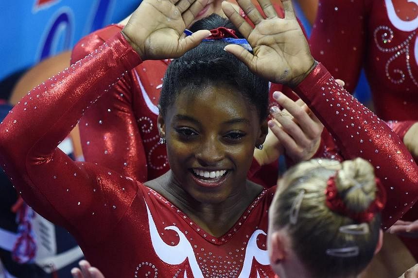 Simone Biles of the US celebrates with team mates after the US team won the women's team final at the Gymnastics World Championships in Nanning, in China's southern Guangxi province on October 8, 2014. -- PHOTO: AFP&nbsp;