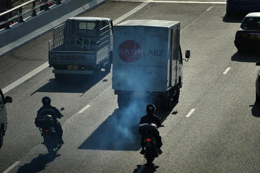 A lorry emitting clouds of white smoke on the Pan-Island Expressway (PIE). -- PHOTO: ST FILE