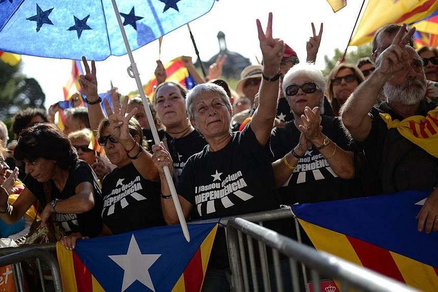 Pro-independence Catalans wait for the Parliament to pass the regional law on vote on Nov 9, as they gather outside the Parliament of Catalonia in Barcelona on Sept 19, 2014. -- PHOTO: AFP