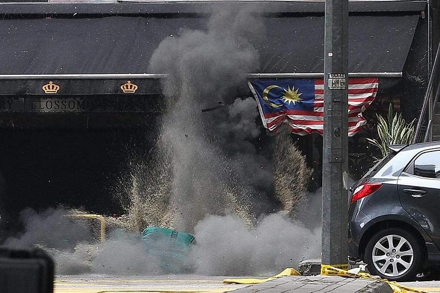 The Singaporean who was among the 13 people injured by a rare grenade blast early Thursday morning is well, but said he is in the dark about what triggered the attack in downtown Kuala Lumpur. -- PHOTO: CHINA PRESS